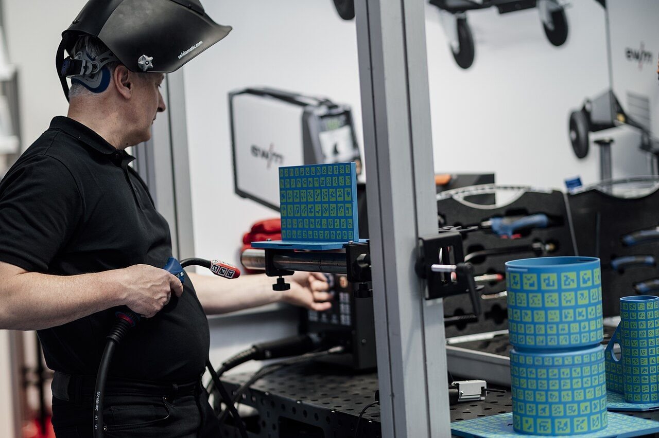 Workers assembling precision industrial components at the factory assembly line