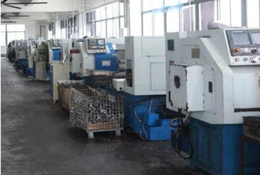 Row of CNC lathes machining cylinder and valve block components