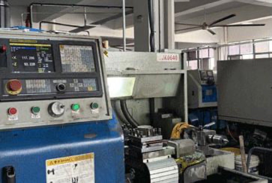 Close-up of a CNC machine control panel running a precision production program