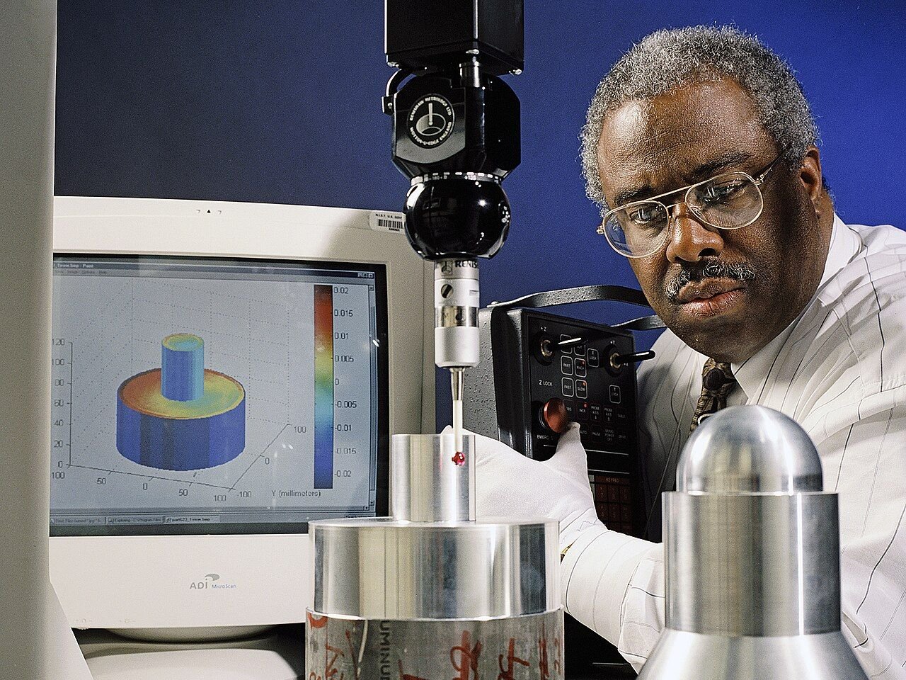 Coordinate measuring equipment inspecting machined metal components for dimensional accuracy