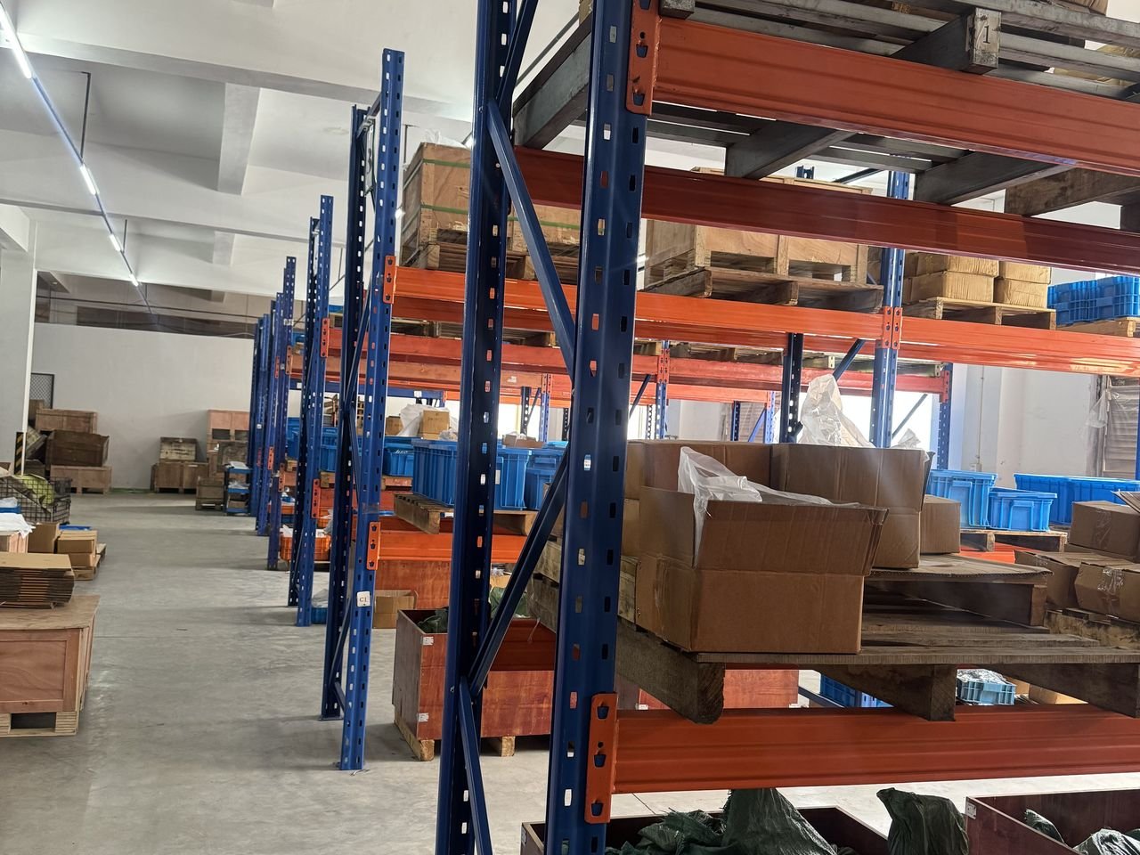 Warehouse shelving with export cartons and packaged components at the Yilong factory
