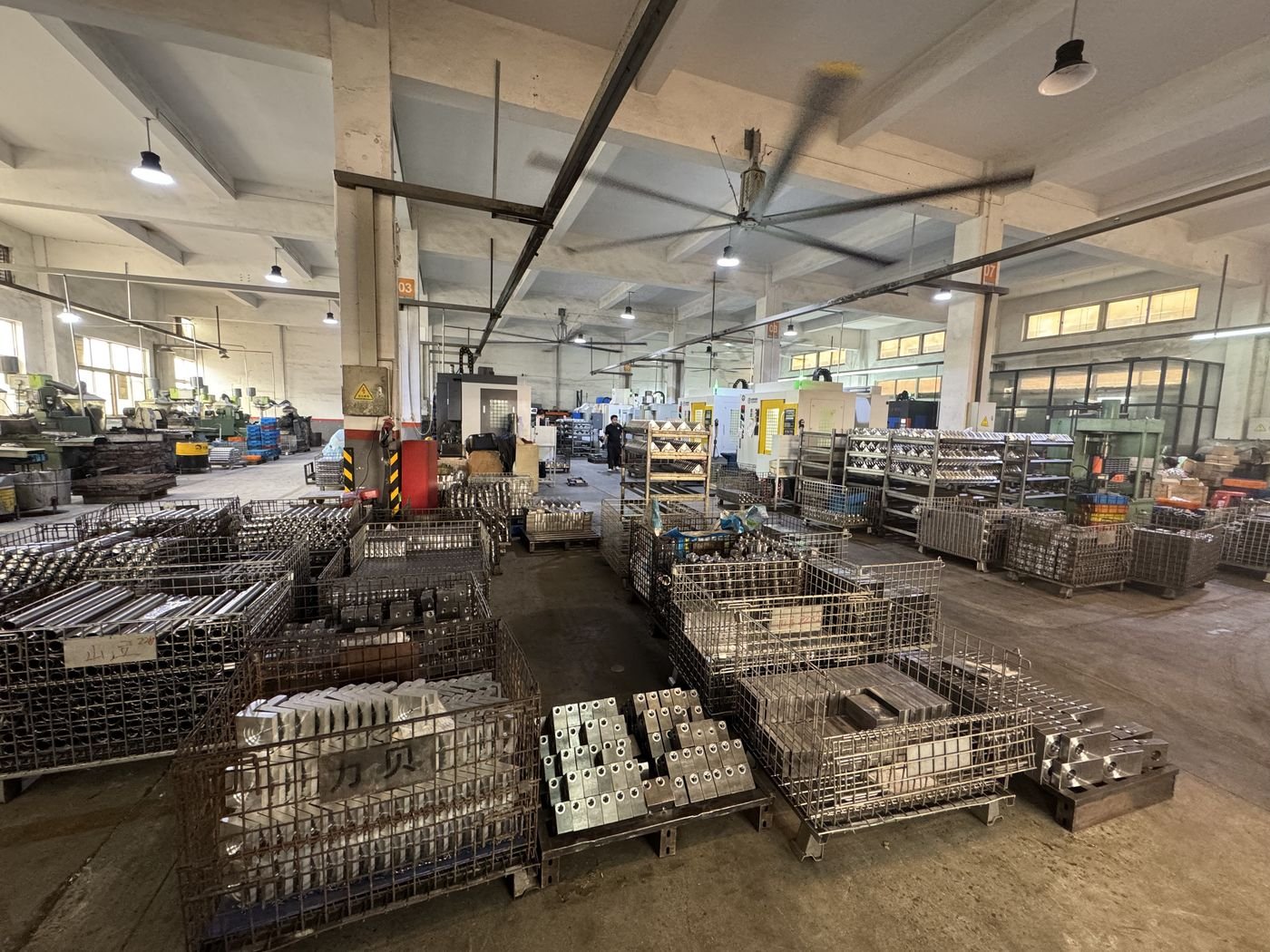 Wide view of the Yilong 5000 square meter production workshop with CNC machines and parts racks