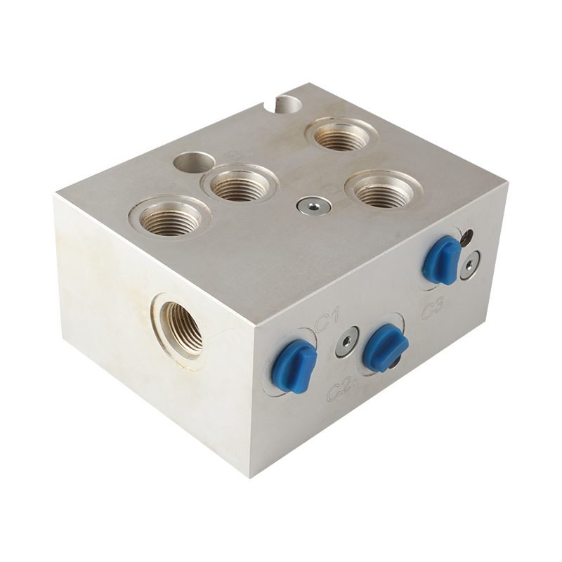 Square hydraulic valve block with blue cartridge valve plugs and tapped ports