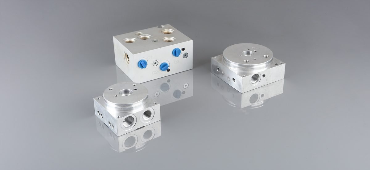 Set of three finished steel hydraulic valve blocks ready for assembly